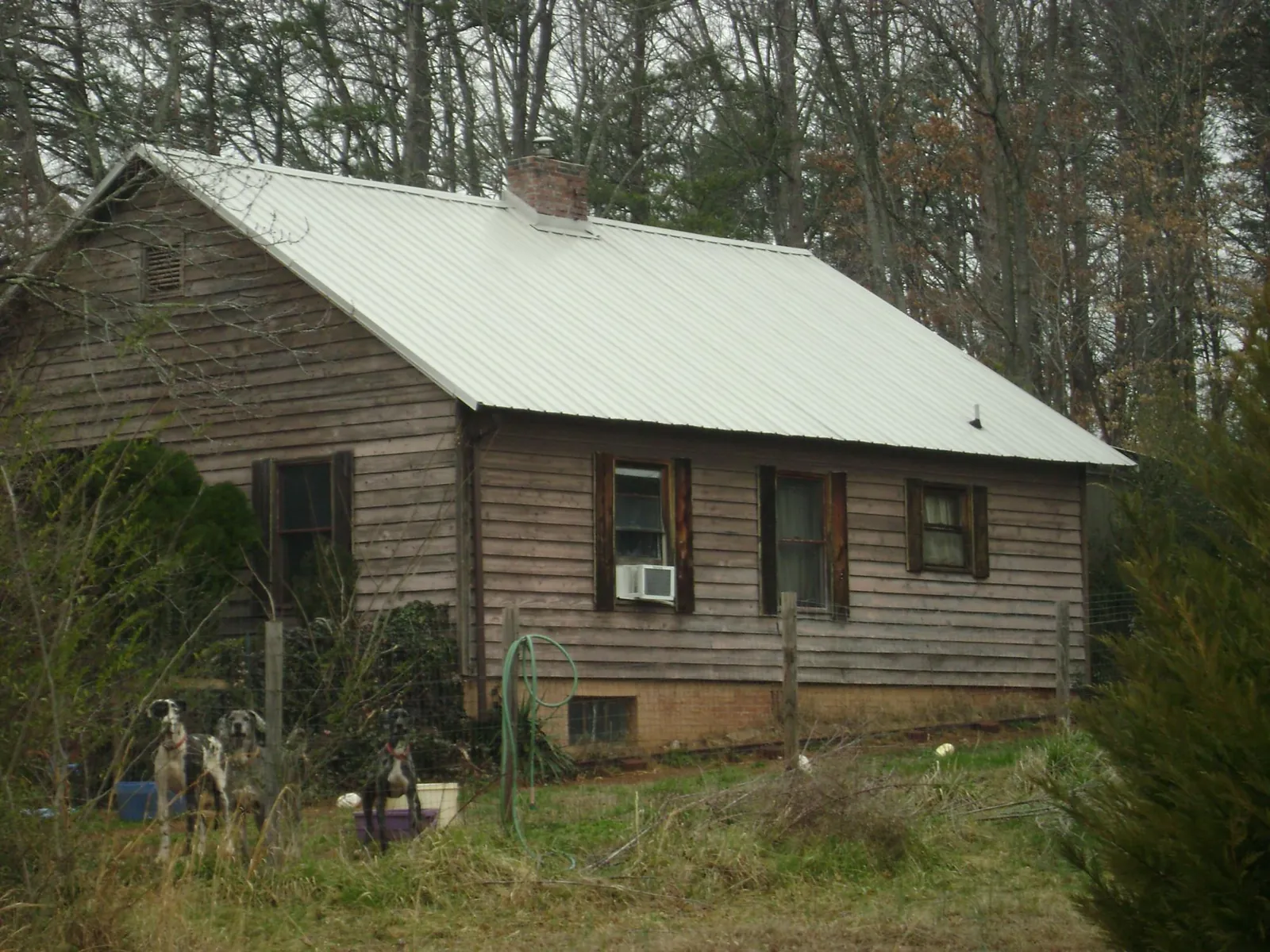 White metal roof on an old wood sided farmhouse, from a Metal Roof Installation job in Sodus